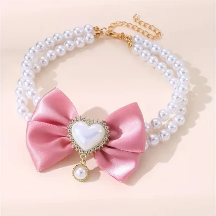 Collar de perlas c/detalle de moño rosado. Talle M