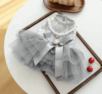 Vestido color plata c/tutu decorado con moño.Trae collar de perlas. Talle M